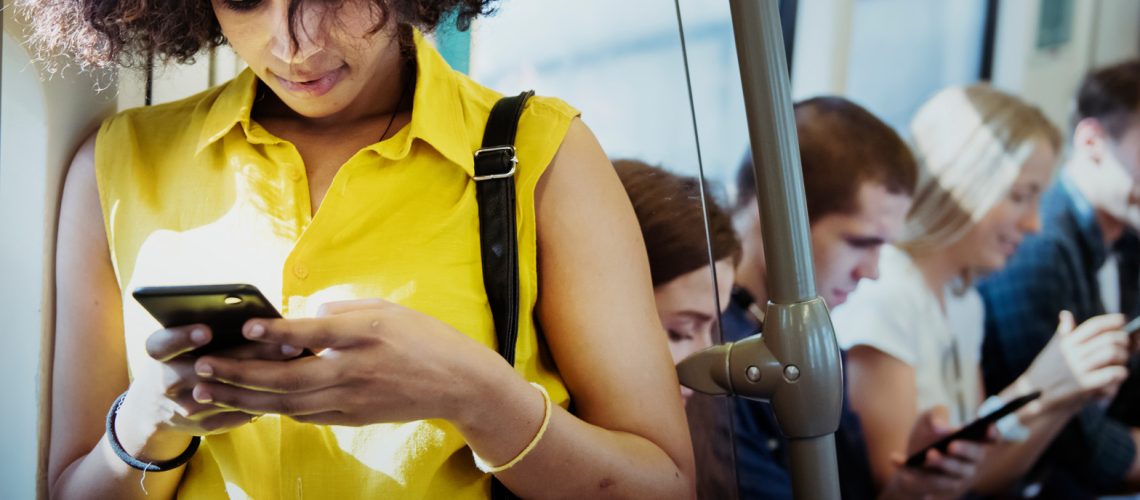 Young woman using a smartphone in a subway